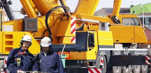 building-workers with giant mobile cranes
